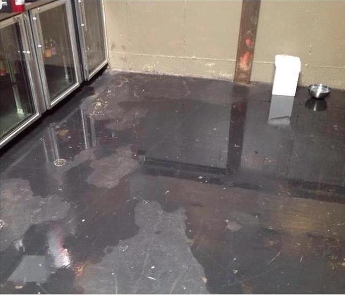 Photo of ground with sitting water on it inside of the building